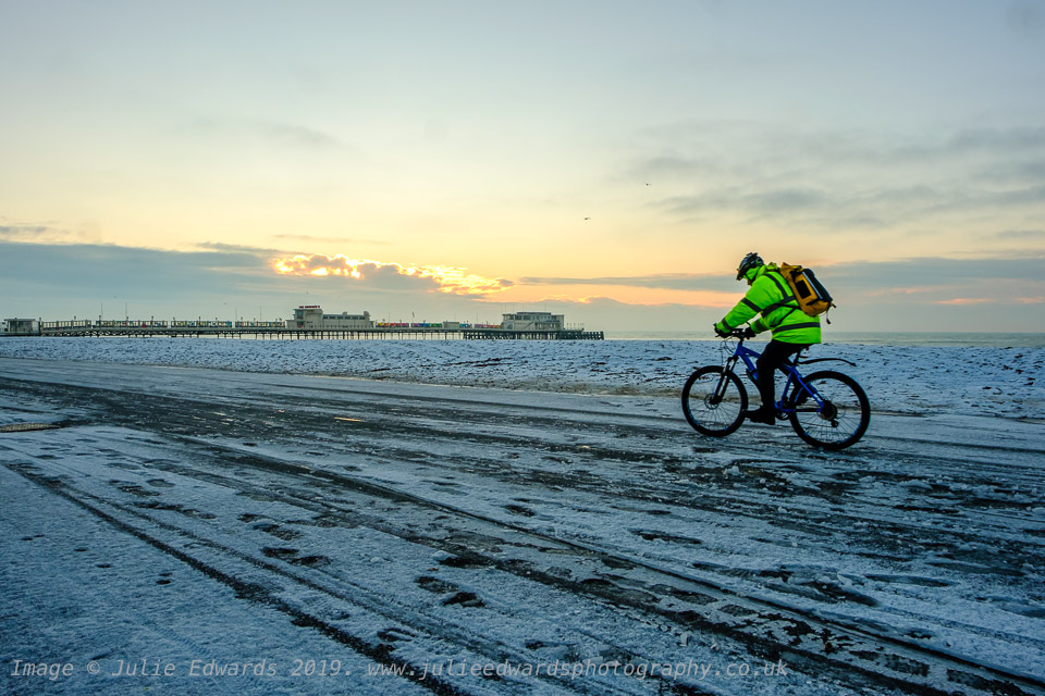 A cyclist rides along the icy promenade as Snow hits the South East of the UK on Friday 1 February 2019